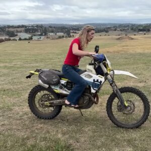 Vanessa Ruck seated on a parked Husqvarna FE 501 with luggage during her Tasmania review